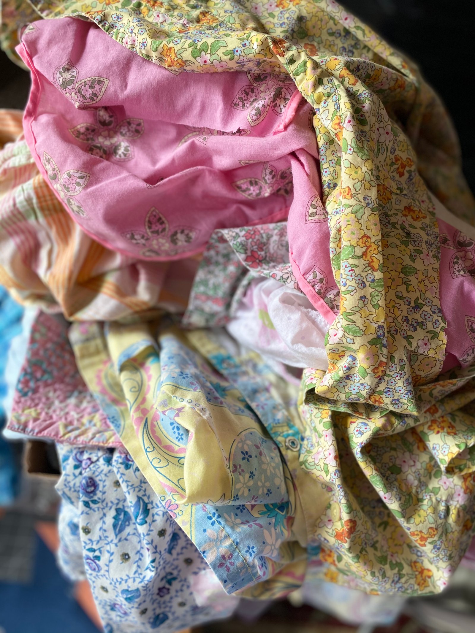 Before — garments and textiles gathered for a family memory quilt